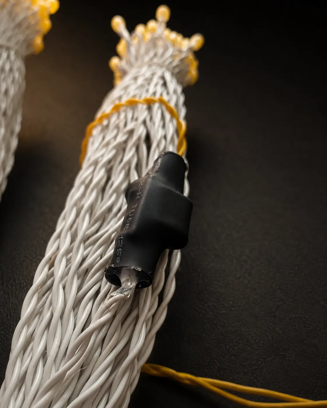 Close-up of the moulded, sealed joint between the wire and an LED on a series light